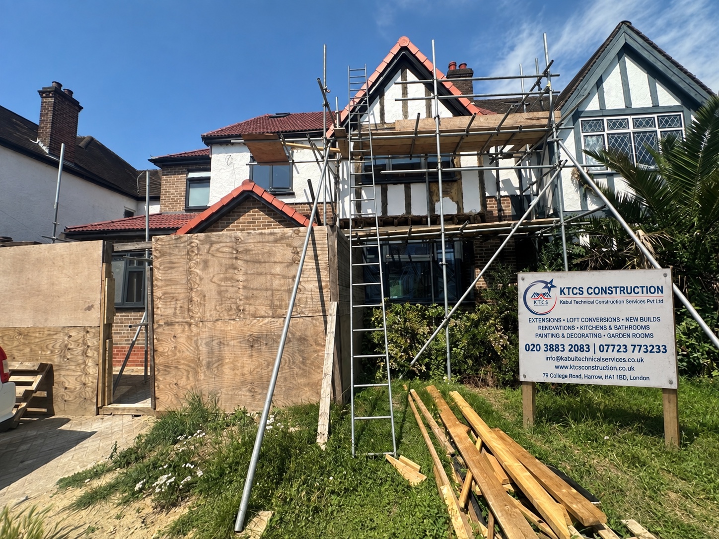 House renovation in progress with scaffolding and a KTCS Construction site board