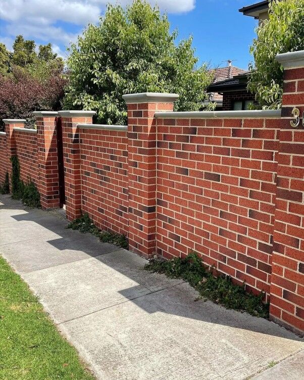 New red-brick front boundary wall with piers and stone copings