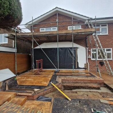 Scaffolding and new foundations for a rear extension on a brick house