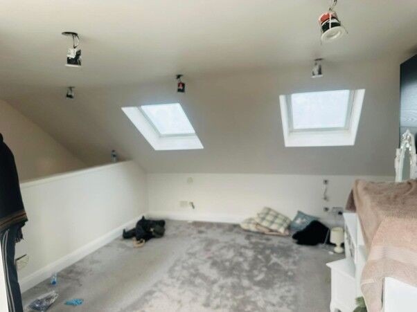 Loft conversion bedroom with two roof windows and new carpet