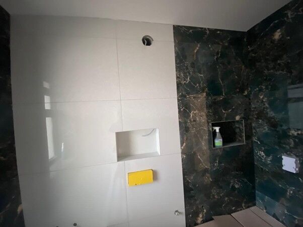 Tiled bathroom wall with a recessed niche