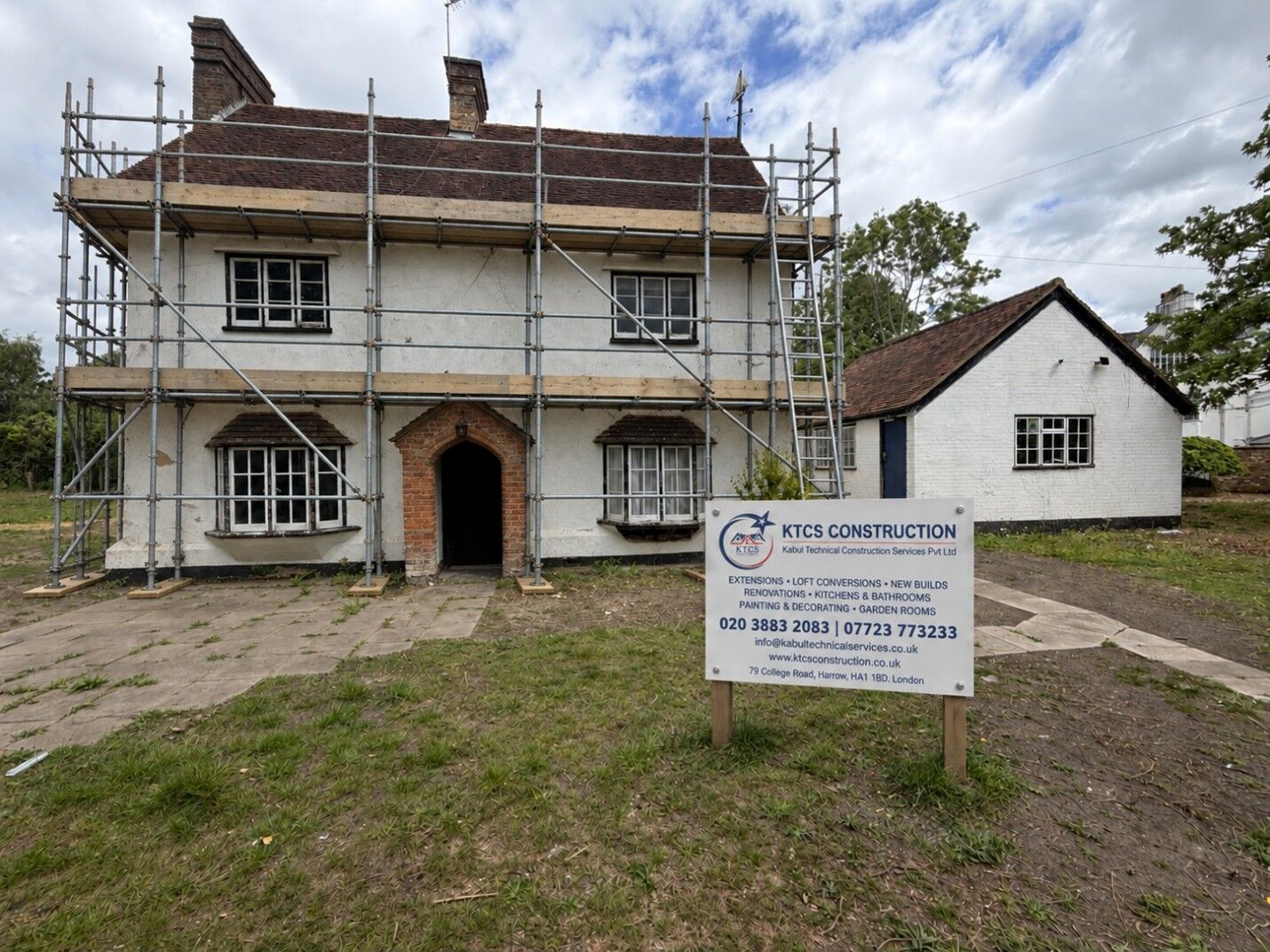Detached house under scaffolding with a KTCS Construction site board