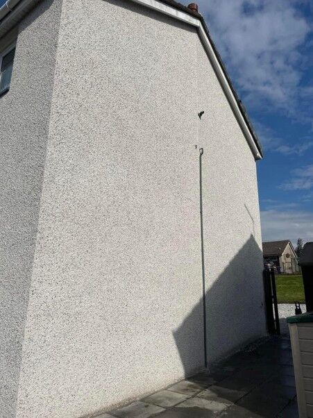 Textured external render on a house gable wall