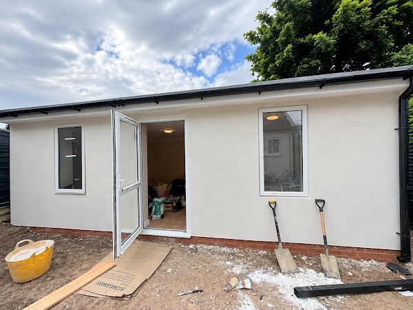 Garden room finished in white render