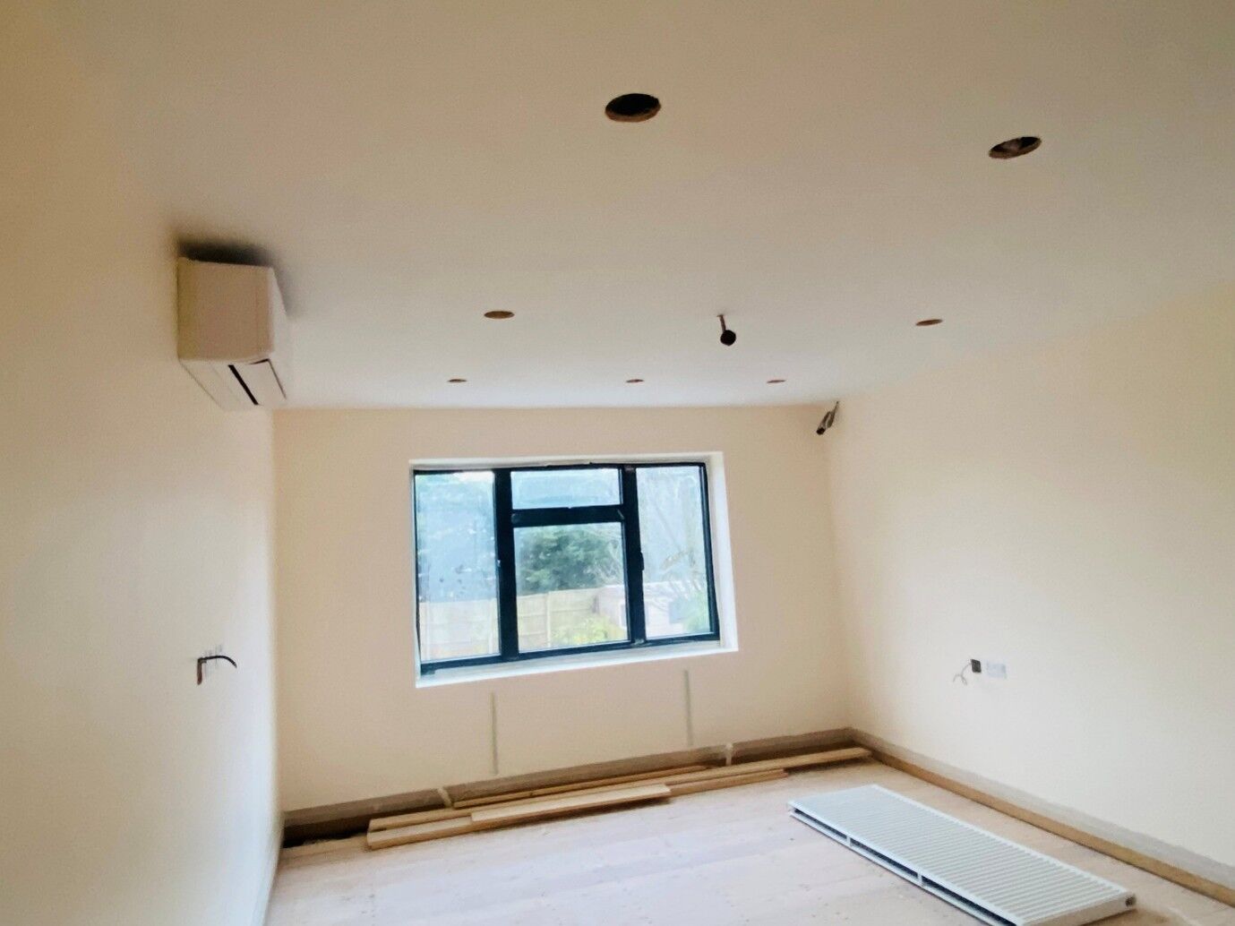 Room fitted with a wall-mounted air-conditioning unit and new sockets