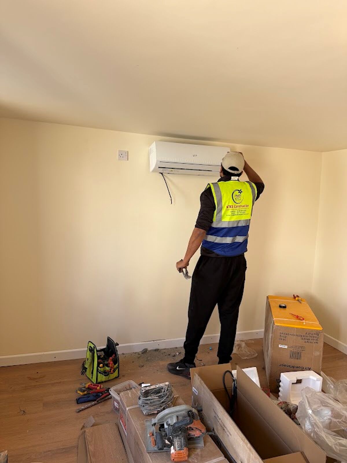 KTCS engineer installing a wall-mounted air-conditioning unit