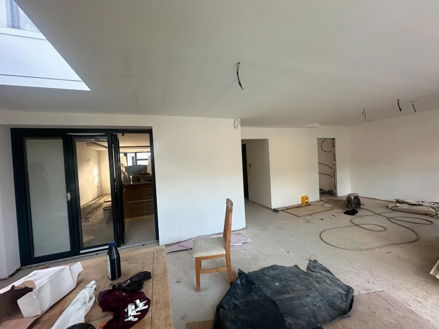 Rear kitchen extension interior with a roof light and bi-fold doors during the Edgware renovation