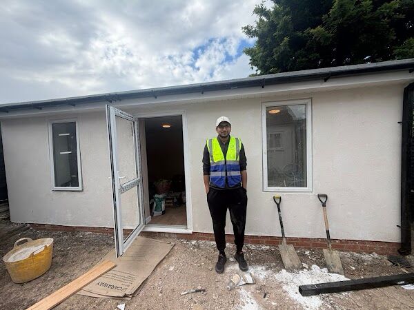 Completed rendered garden room in South Harrow, HA2, with a glazed door and two windows