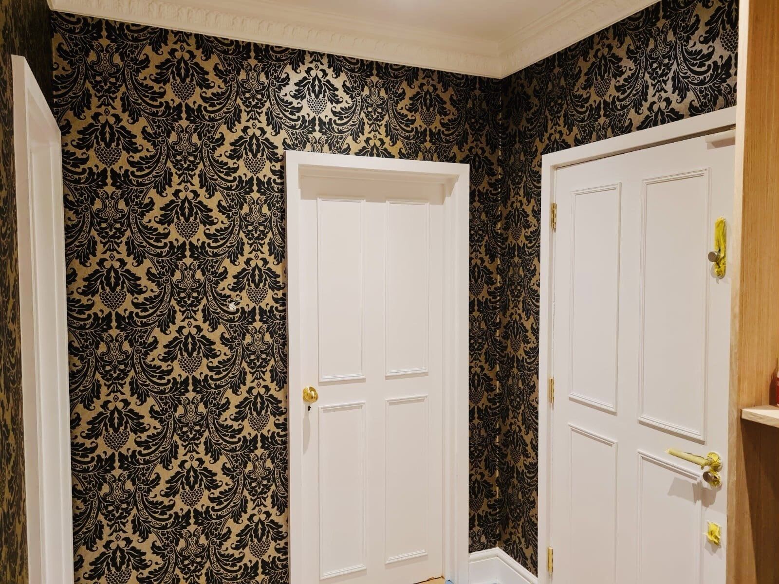 Damask wallpaper hung neatly around panelled doors in the Ealing W5 property